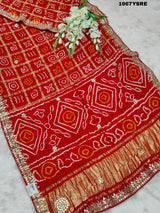 A red Gaji silk Bandhani saree Gota patti work