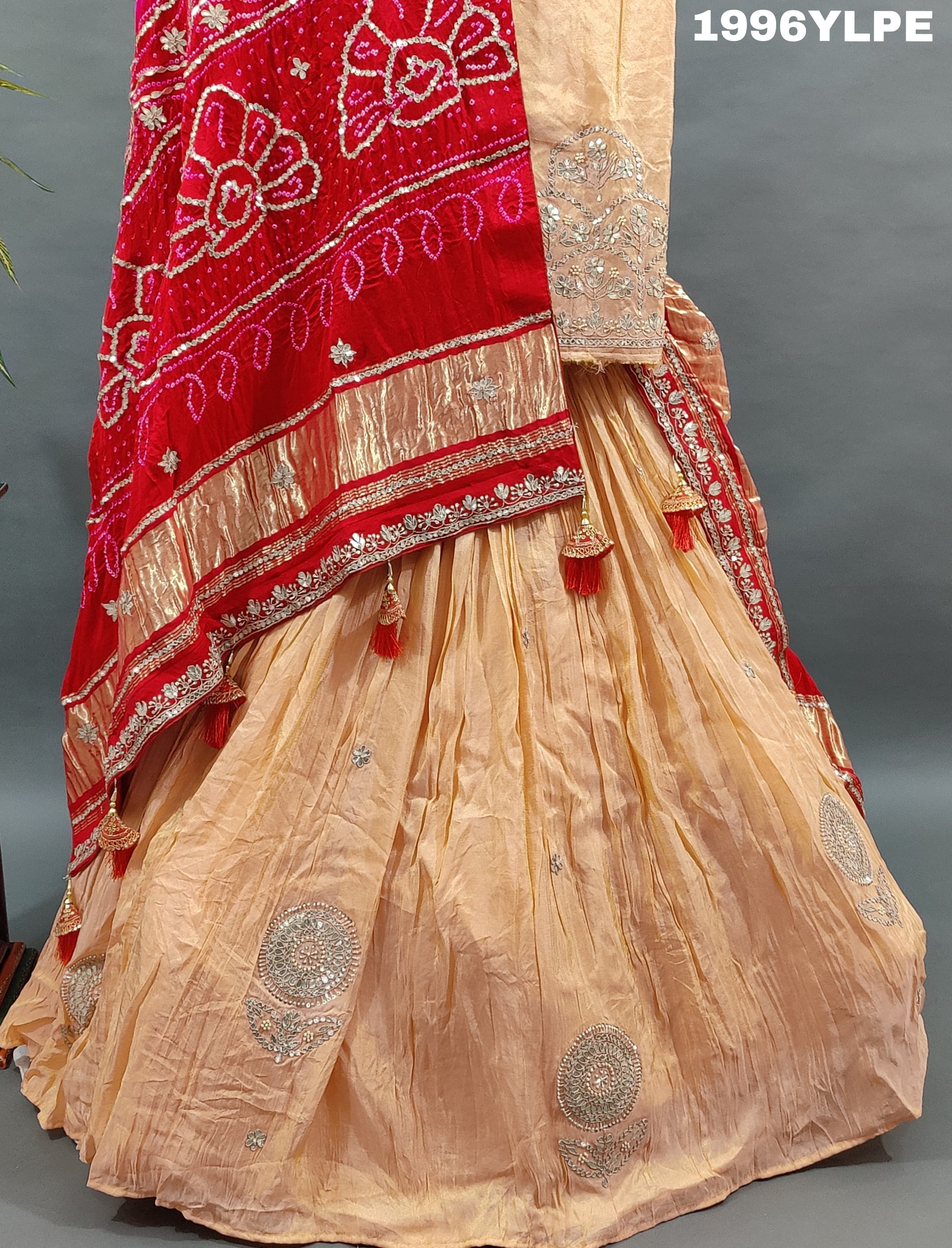 A traditional Indian lehanga with pure Gaji silk Jaipuri stylegotapatti work. 