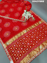 A red and orange bandhani style saree with gota patti work