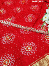 A red and orange bandhani style saree with gota patti work