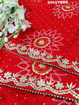 A red and orange bandhani style saree with gota patti work