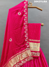 A pink Gaji silk lehenga with floral patterns and gold embellishments