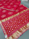 A red and pink silk saree with bandhani style dots and gota patti work