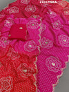 A pink and red traditional Indian saree with floral patterns and gota work.