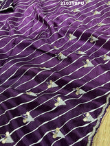 A purple dola silk saree with pearl gotapatti work