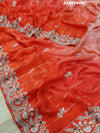 A red saree with silver and gold sequence cutdana work pattern.