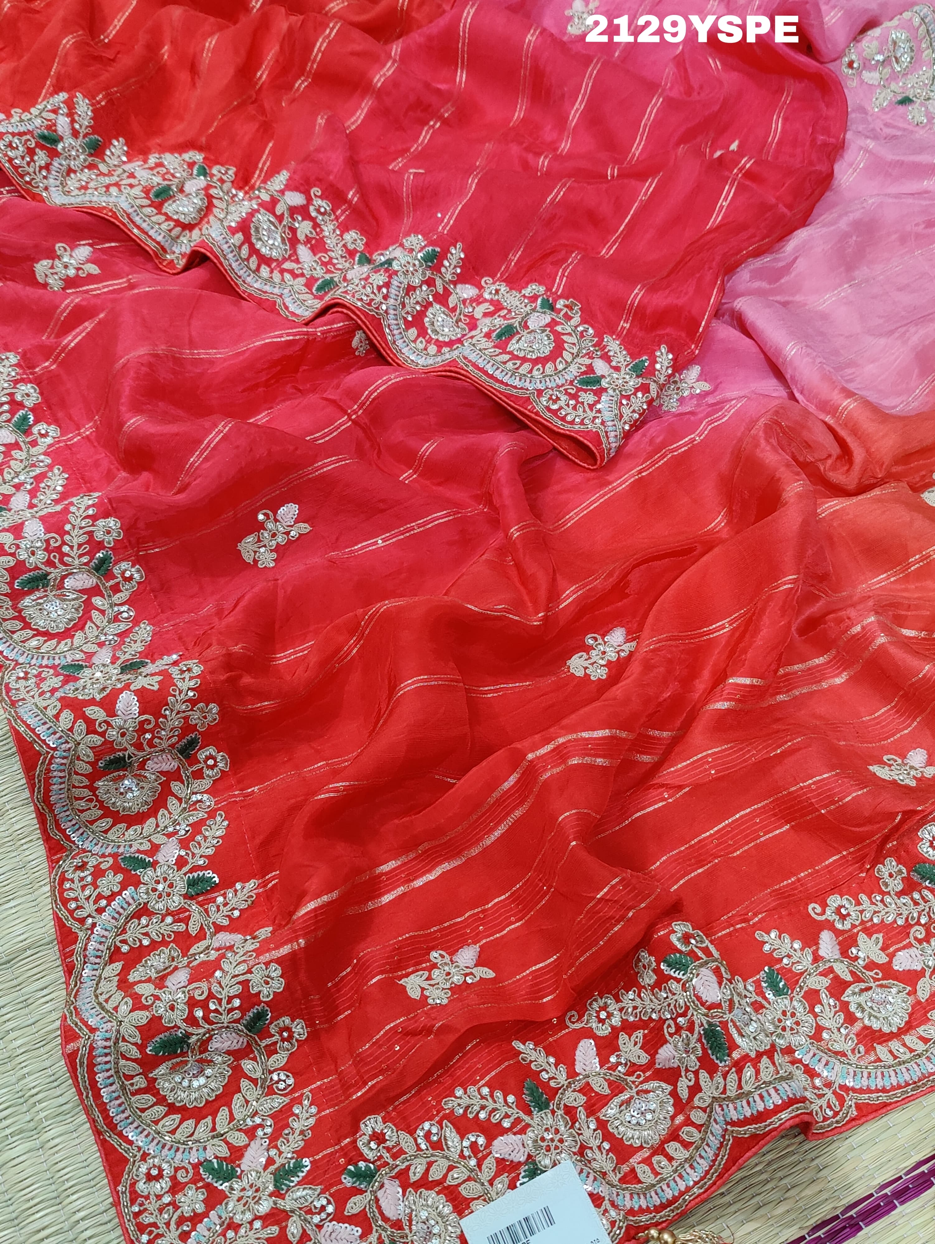 red saree with golden and silver embellishments and cutdana work, showcasing a traditional and festive design.