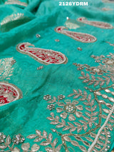 A green saree with red and silver paisley patterns and detailed embroidery, 