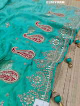 A green saree with red and silver paisley patterns and detailed embroidery, 
