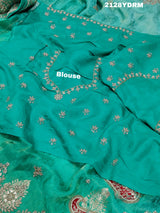 A green saree with red and silver paisley patterns and detailed embroidery, 