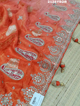 An orange saree with silver paisley pattern and floral gotapatti work, along with sequence embellishments.