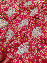 A red and gold Munga silk saree with Zardoji work and patola print style