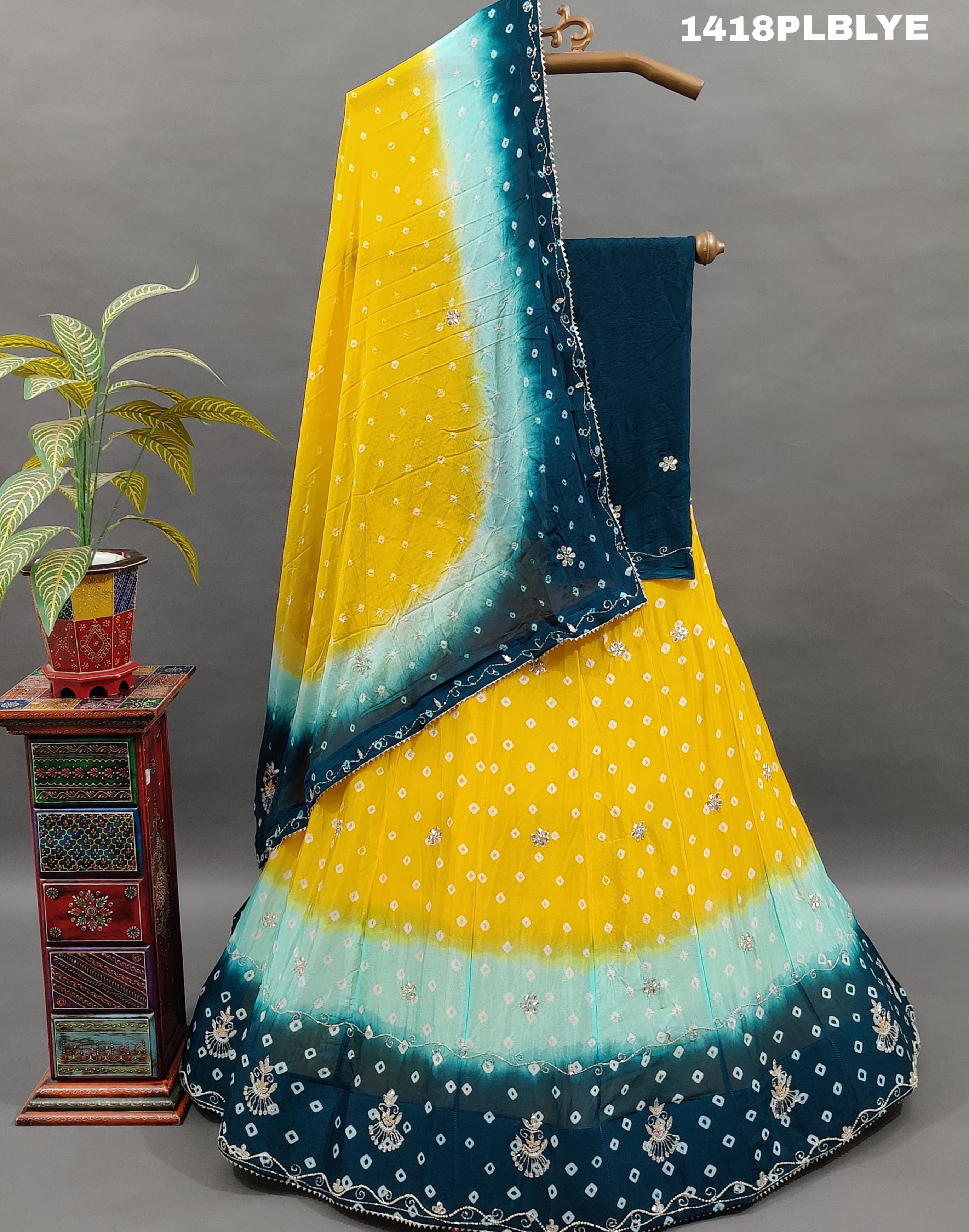 A traditional Indian lehenga with a multicolor bandhani pattern 