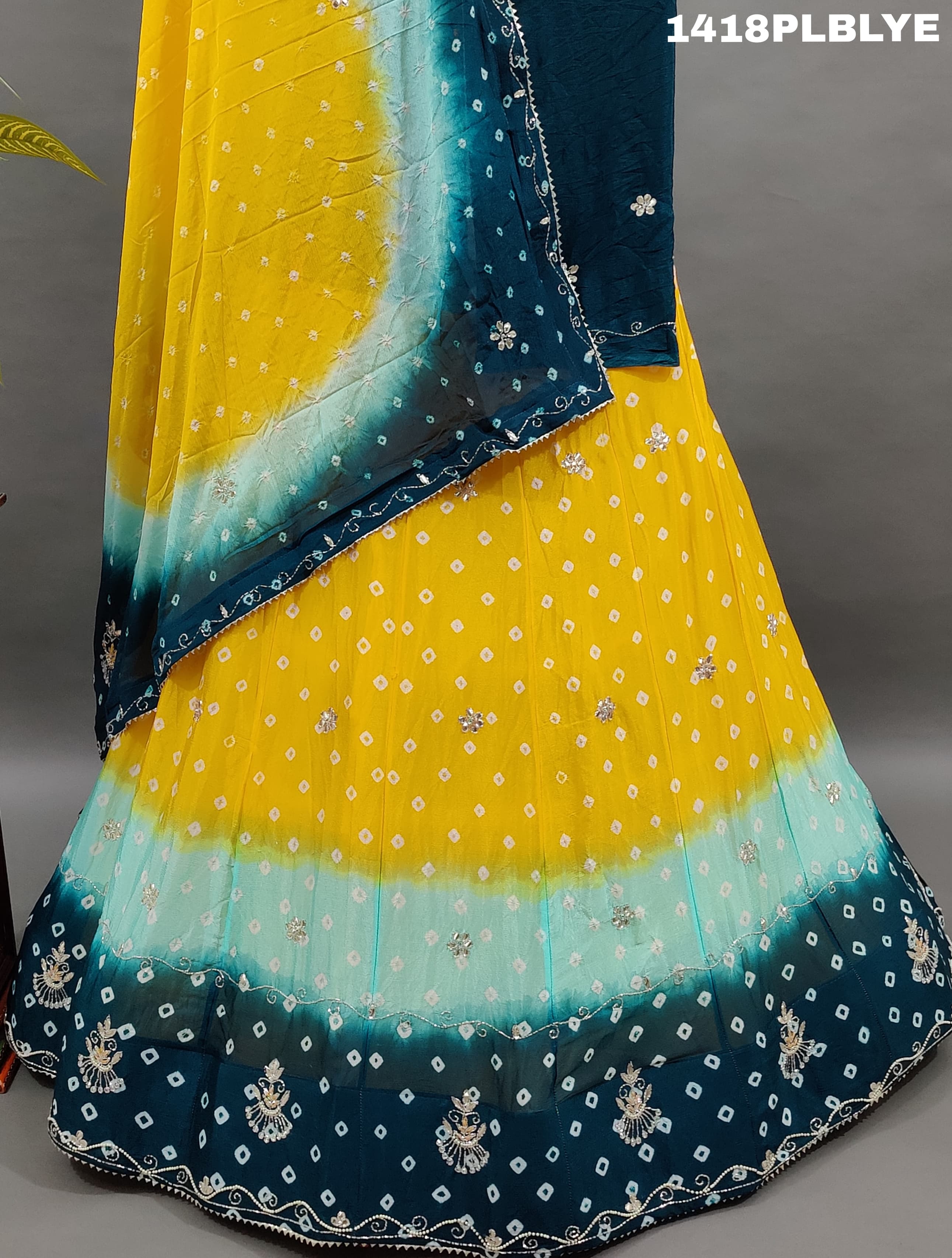 A traditional Indian lehenga with a multicolor bandhani pattern 