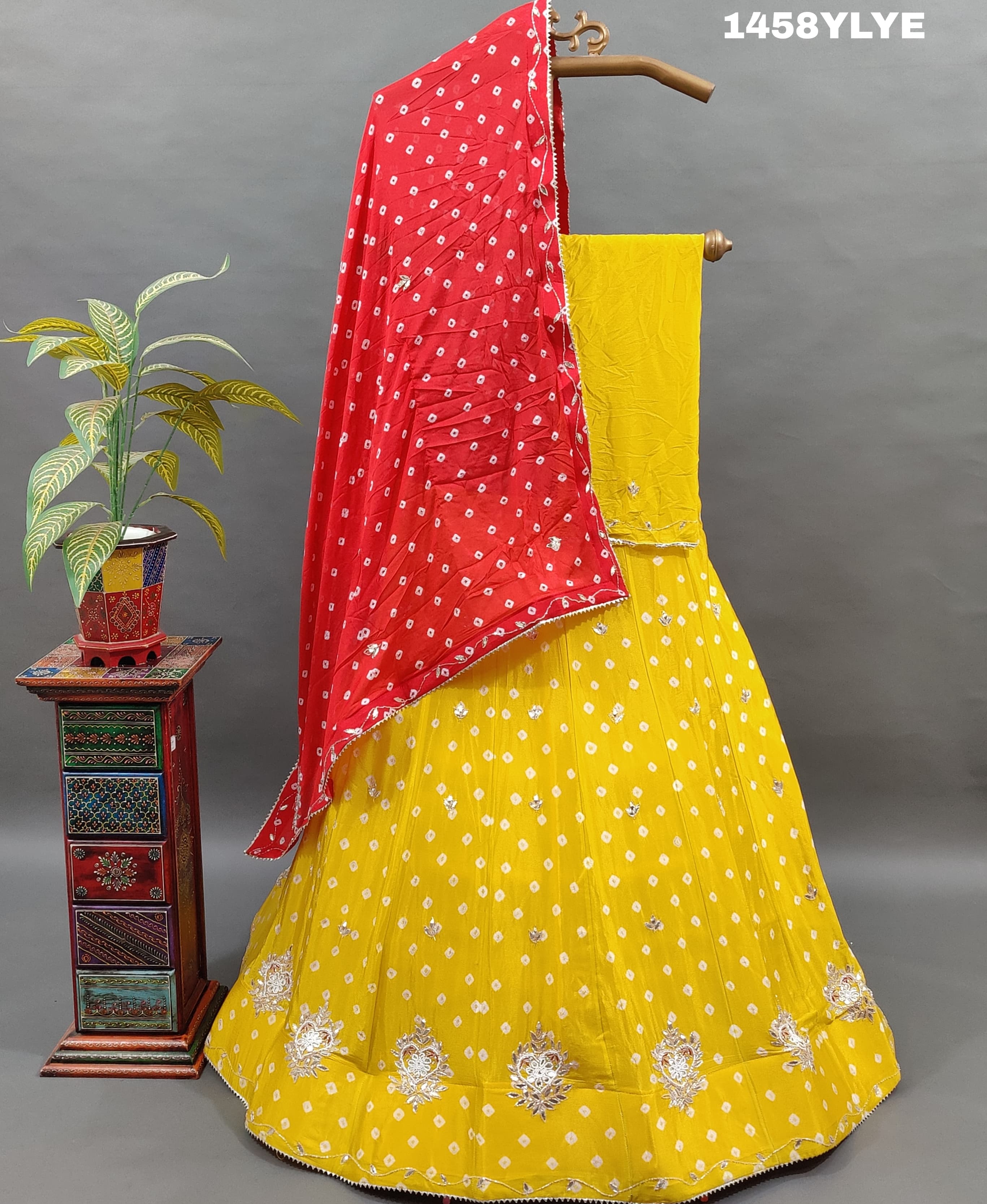 A traditional yellow lehenga with red bandhani style 