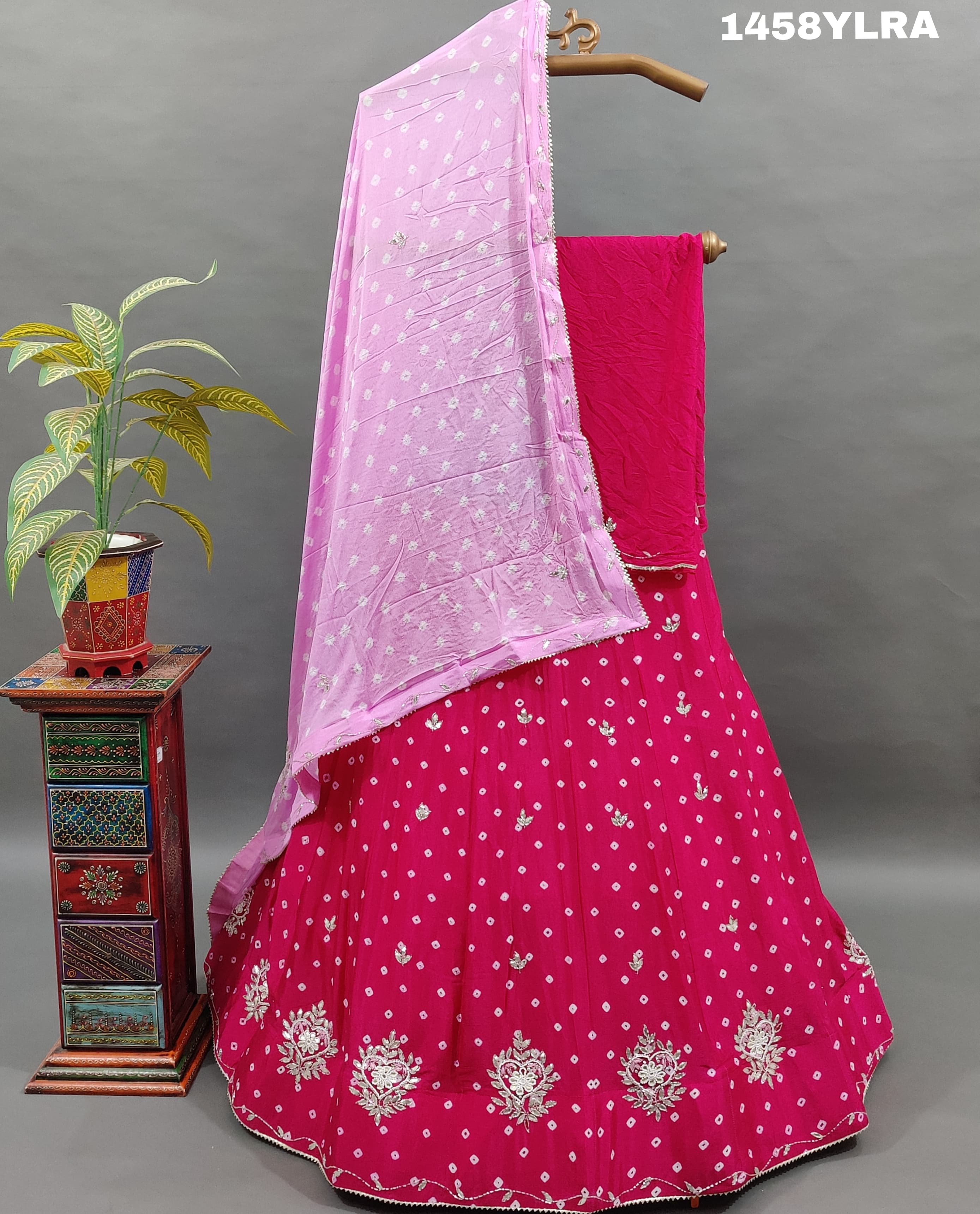 A traditional wear lehenga in pink color with bandhani style 