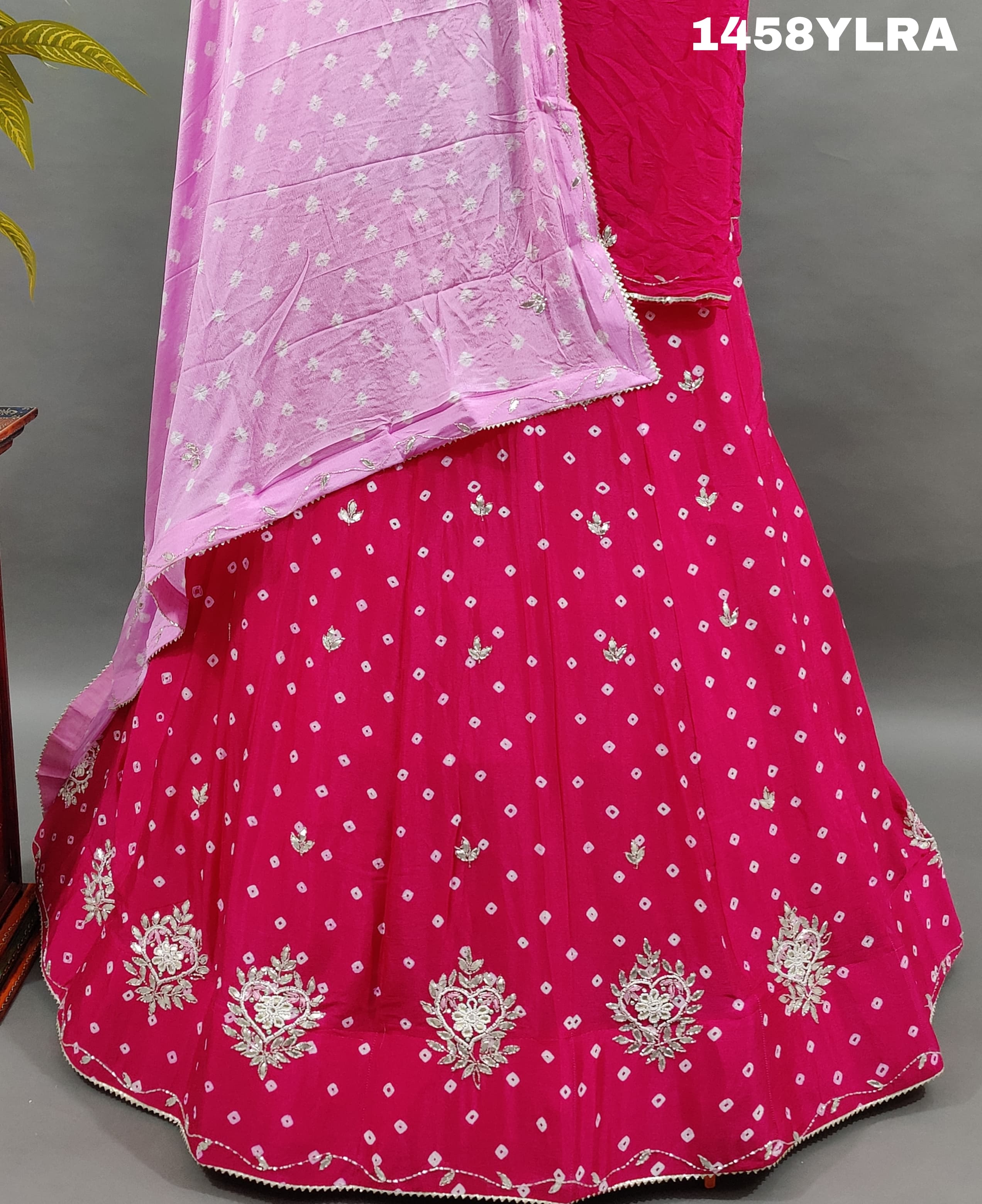 A traditional wear lehenga in pink color with bandhani style 