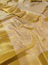 A yellow and gold tissue silk saree with Banarasi zari border
