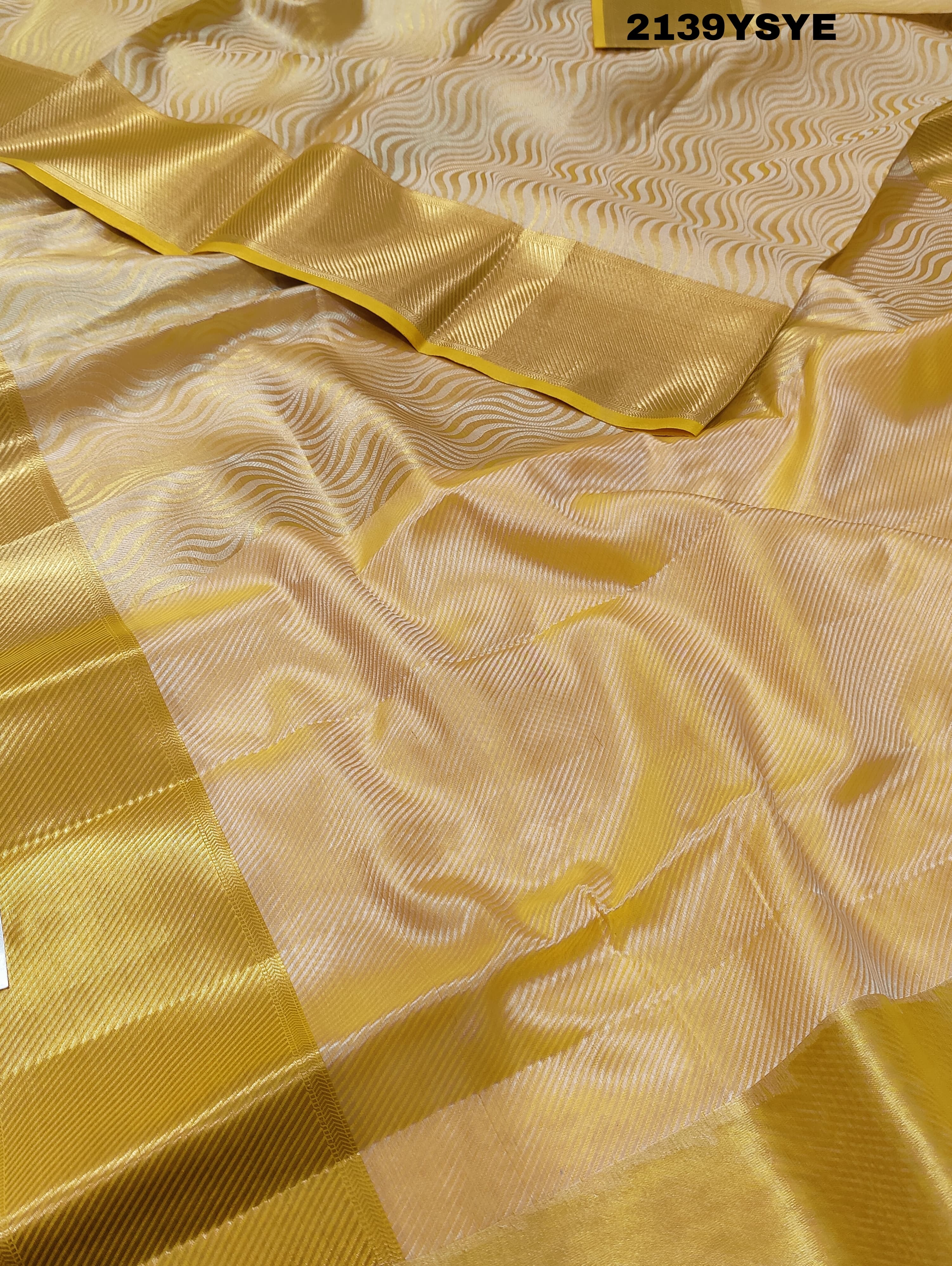 A yellow and gold tissue silk saree with Banarasi zari border