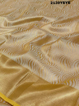 A yellow and gold tissue silk saree with Banarasi zari border
