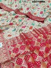 A Banarasi silk saree with a Meenakari pattern featuring a cream body with multicolor floral designs and a red border.