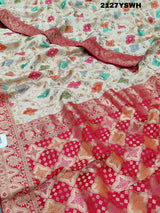 A Banarasi silk saree with a Meenakari pattern featuring a cream body with multicolor floral designs and a red border.