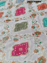 A Banarasi silk saree with a Meenakari pattern featuring a cream body with multicolor floral designs and a red border.