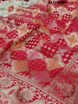 A Banarasi silk saree with a Meenakari pattern featuring a cream body with multicolor floral designs and a red border.