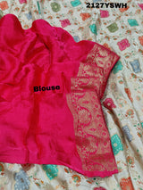 A Banarasi silk saree with a Meenakari pattern featuring a cream body with multicolor floral designs and a red border.