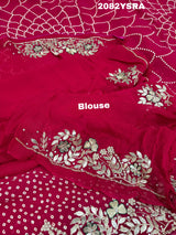 A pink saree with bandhani style dots and gotapatti work 