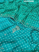 A green saree with bandhani pattern and cutdana work 