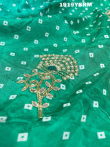 A green saree with bandhani pattern and cutdana work 