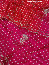 A saree with a bandhani pattern and cutdana work, predominantly pink with red accents.