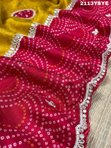 A yellow and red bandhani style dola silk saree with gota patti work