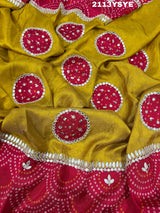 A yellow and red bandhani style dola silk saree with gota patti work