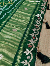 A green and silver pure gaji silk saree with bandhani pattern and gotapatti handwork, displayed on a surface.