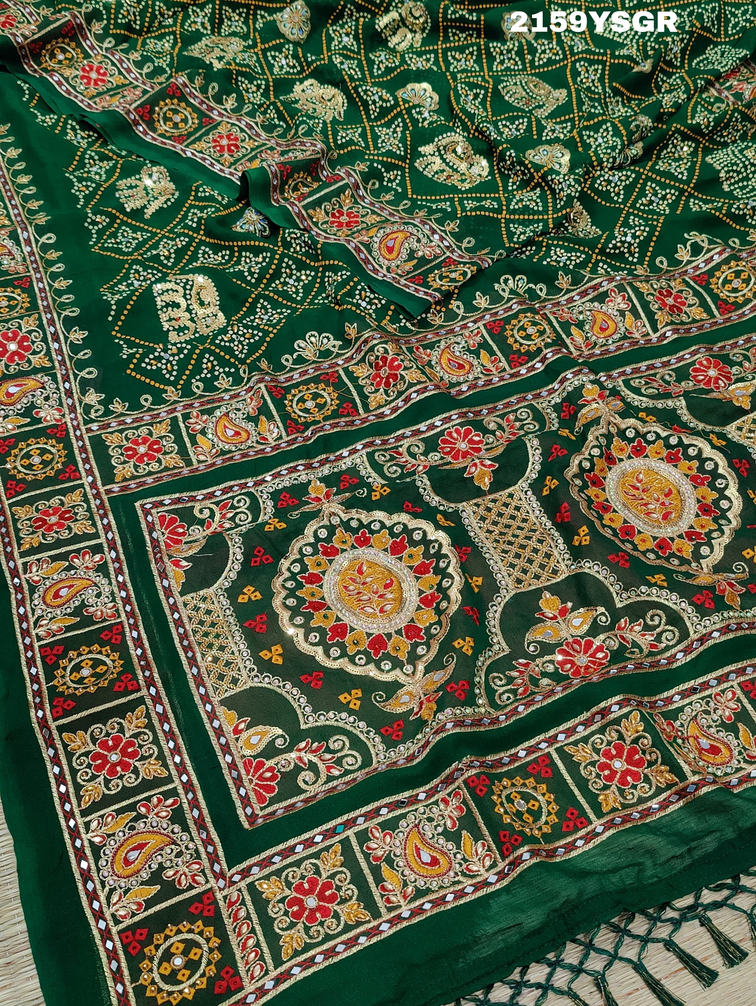 A green saree with traditional Jaipuri Rajwadi style embroidery and bandhani patterns, including real vintage mirror work.
