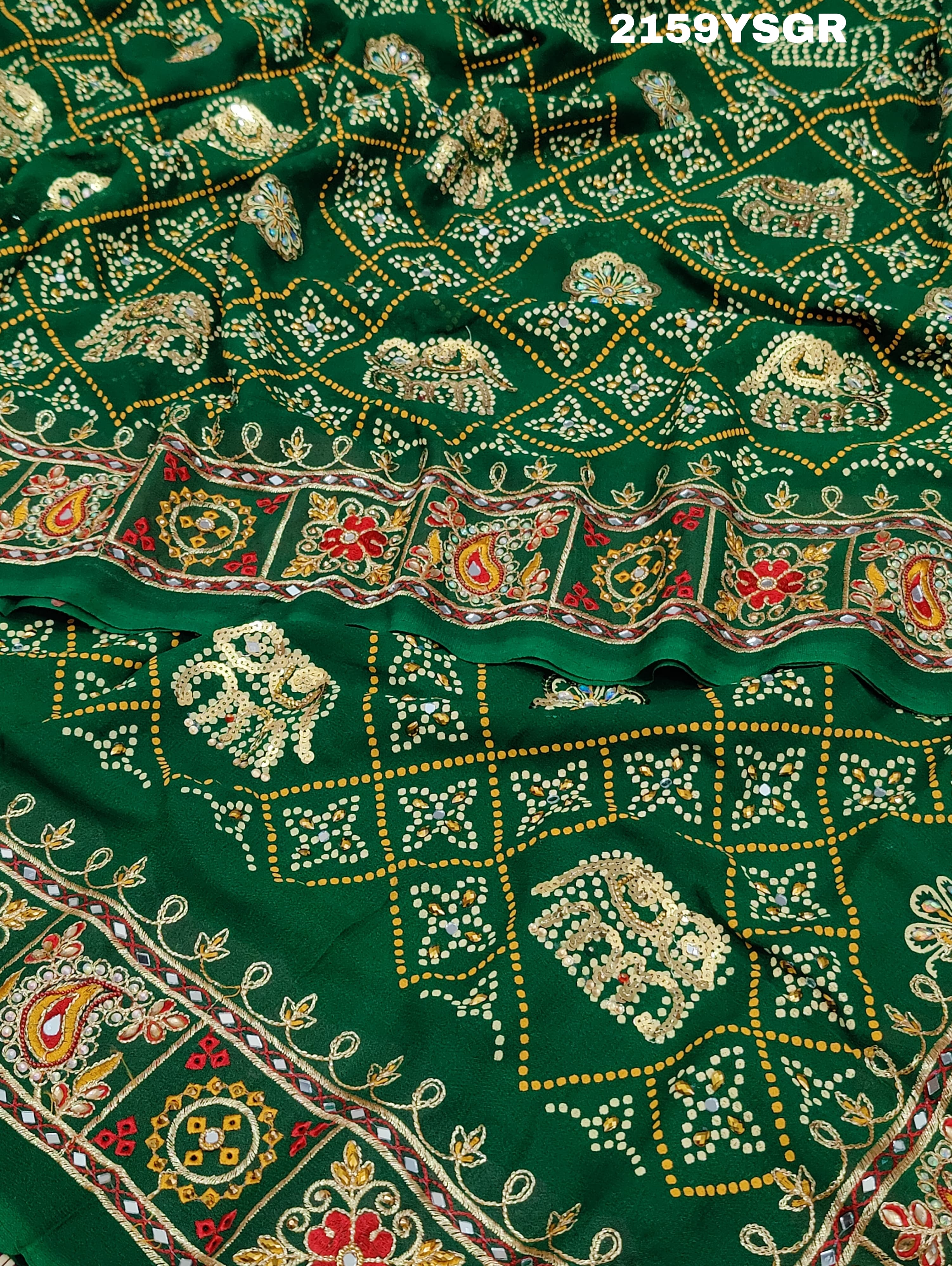 A green saree with traditional Jaipuri Rajwadi style embroidery and bandhani patterns, including real vintage mirror work.