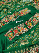 A green saree with traditional Jaipuri Rajwadi style embroidery and bandhani patterns, including real vintage mirror work.