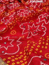 A red and silver bandhani style silk saree with mirror handwork, including floral patterns and a traditional design.