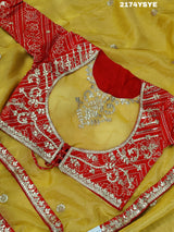 A yellow and red tissue silk saree with Bollywood style embellishments and gotapatti work.