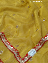 A yellow and red tissue silk saree with Bollywood style embellishments and gotapatti work.