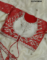 A red and white tissue silk saree with Bollywood style embellishments and gotapatti work.