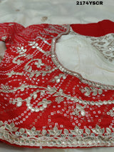 A red and white tissue silk saree with Bollywood style embellishments and gotapatti work.
