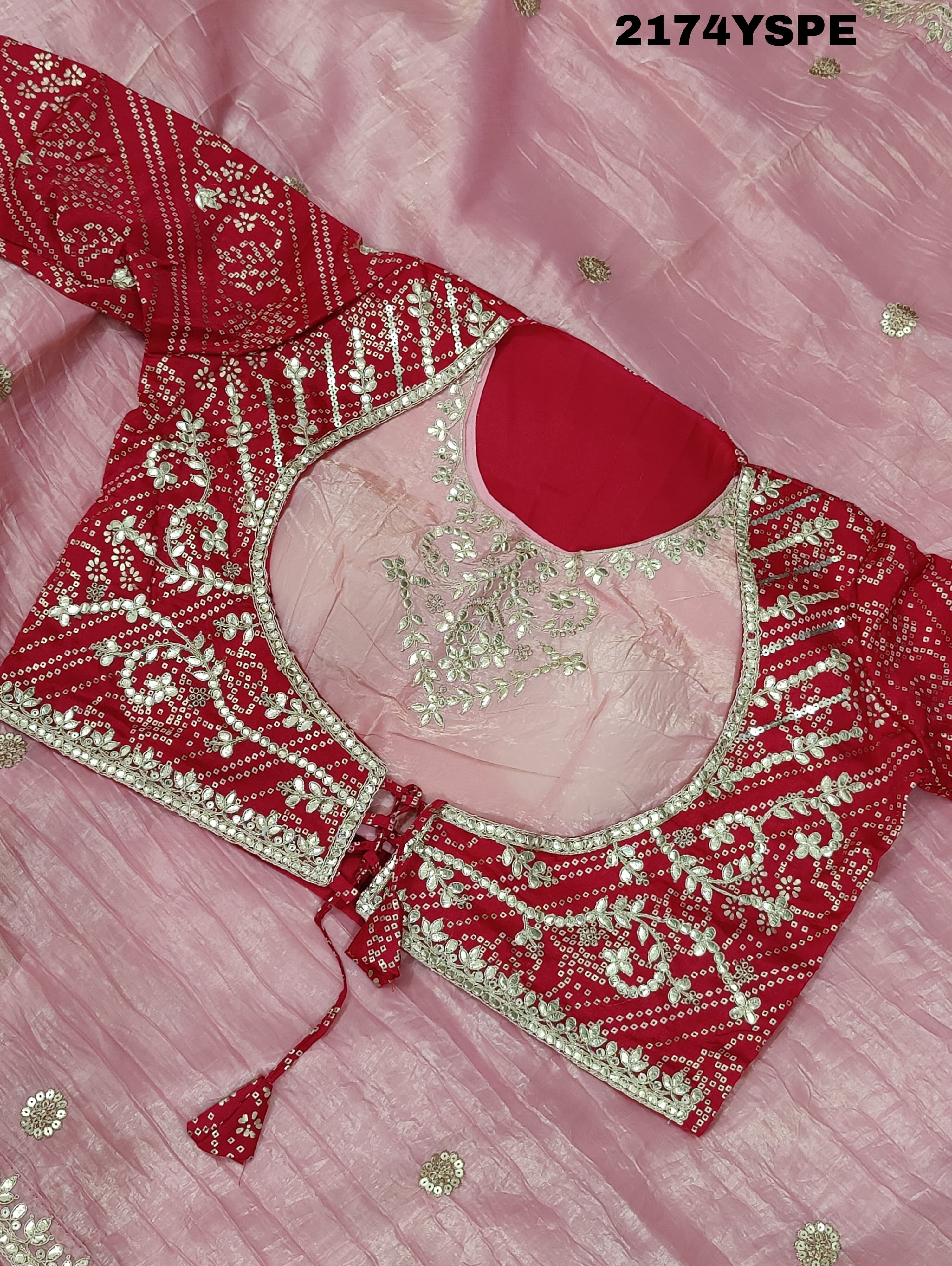 A saree with tissue silk fabric featuring Bollywood style embellishments and gotapatti work in red and pink colour