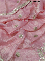 A saree with tissue silk fabric featuring Bollywood style embellishments and gotapatti work in red and pink colour