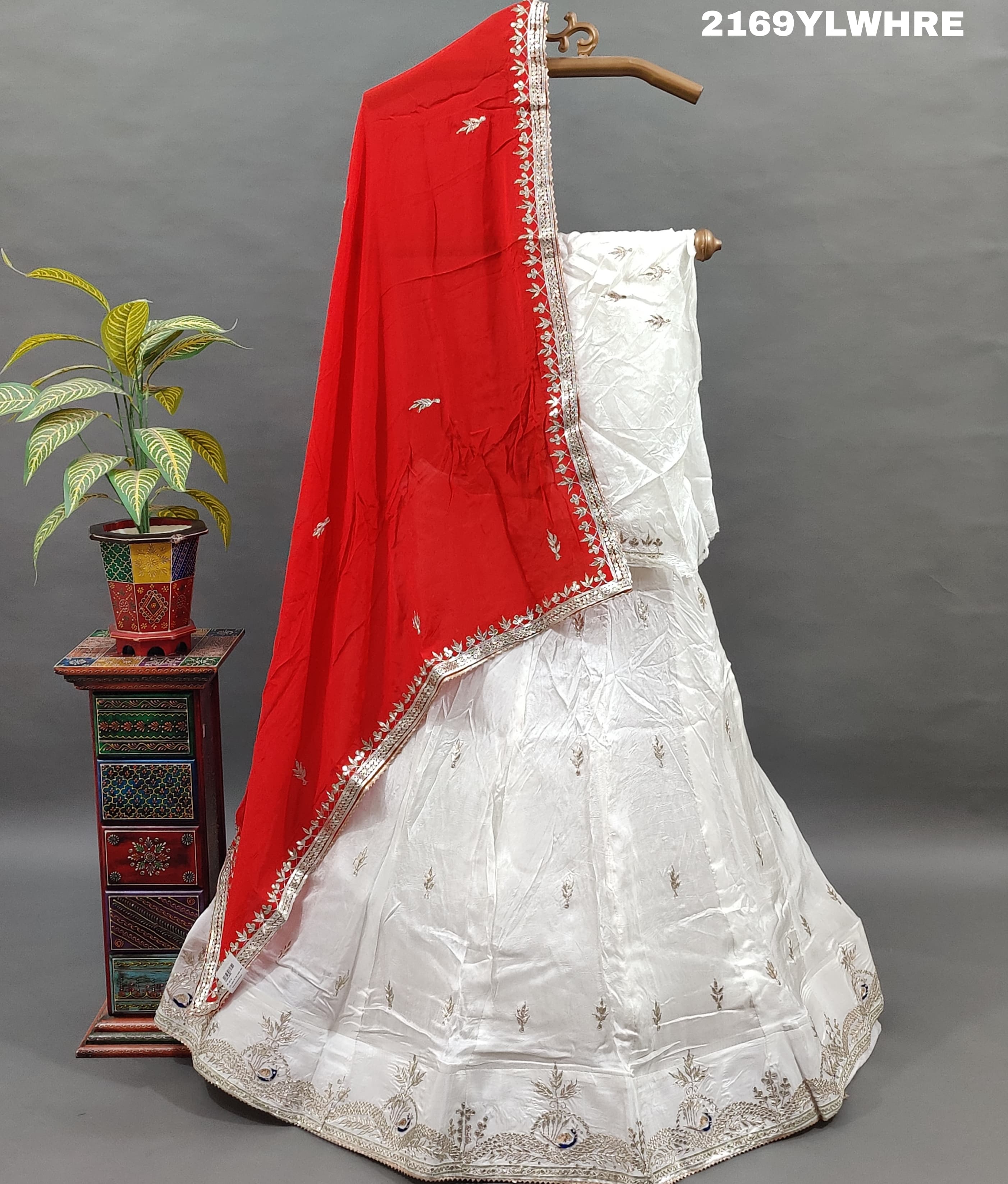 A traditional wear lehenga in white with gotapatti work