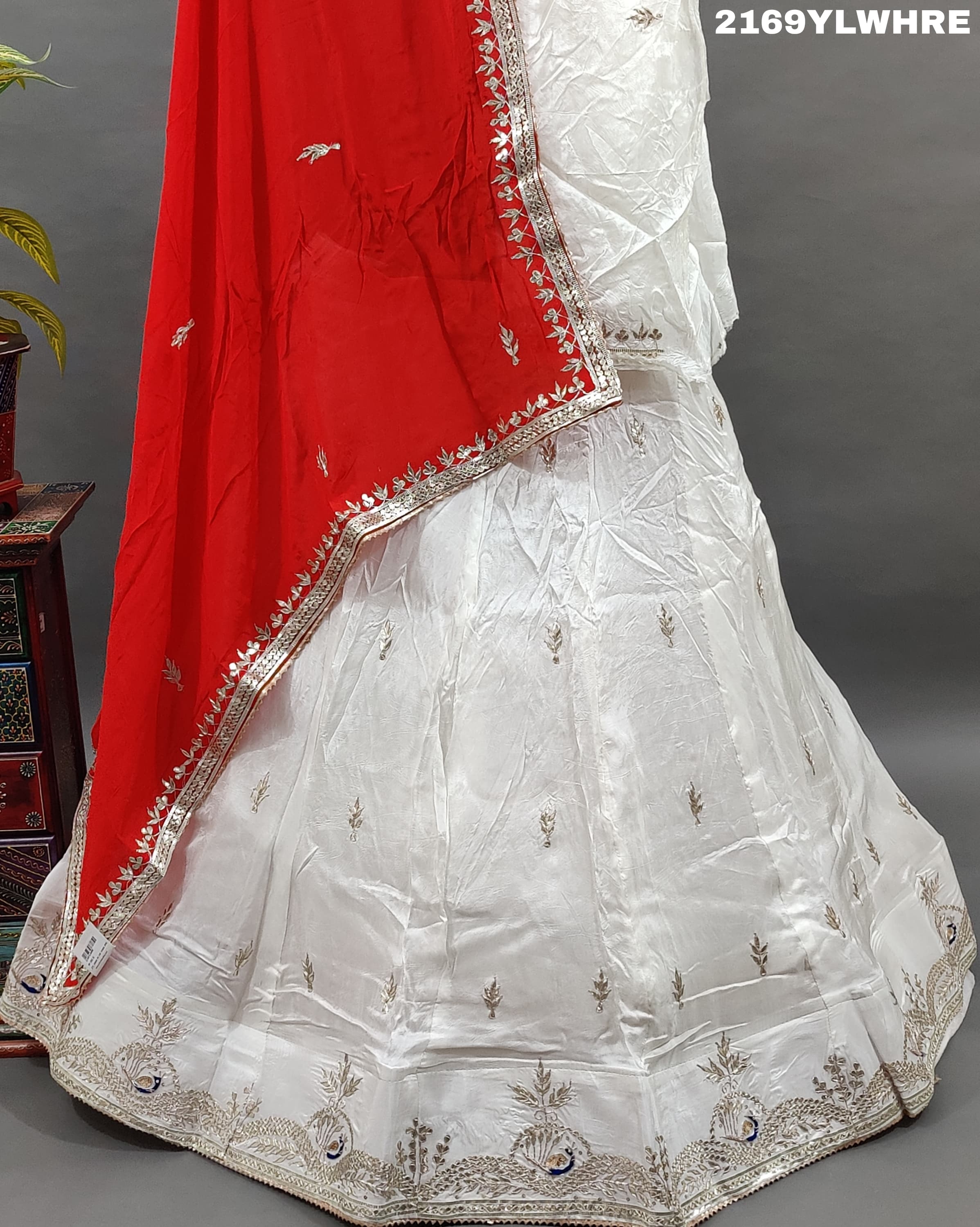 A traditional wear lehenga in white with gotapatti work