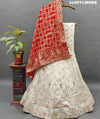 A Lehenga with white beads work and red and orange dupatta