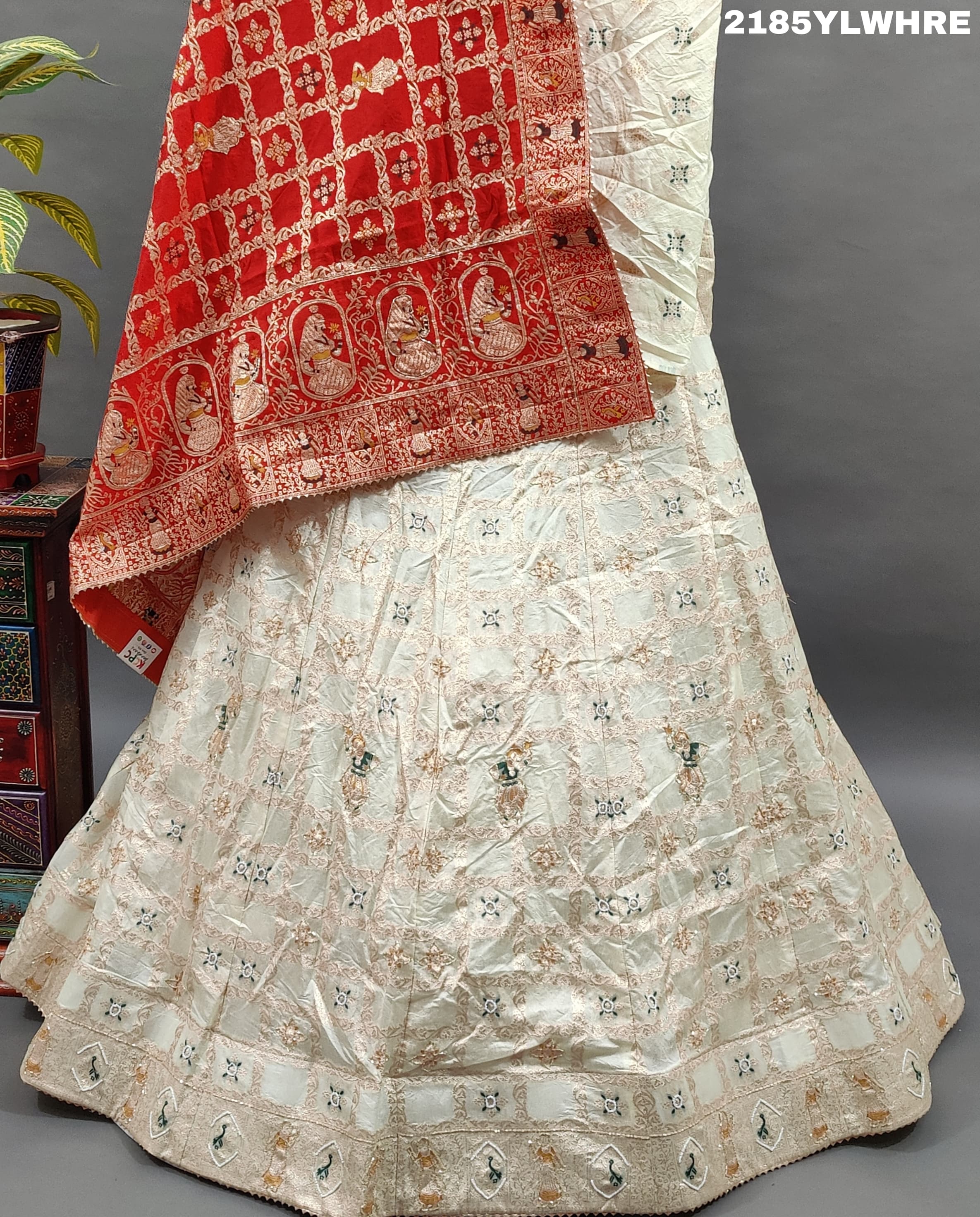 A Lehenga with white beads work and red and orange dupatta